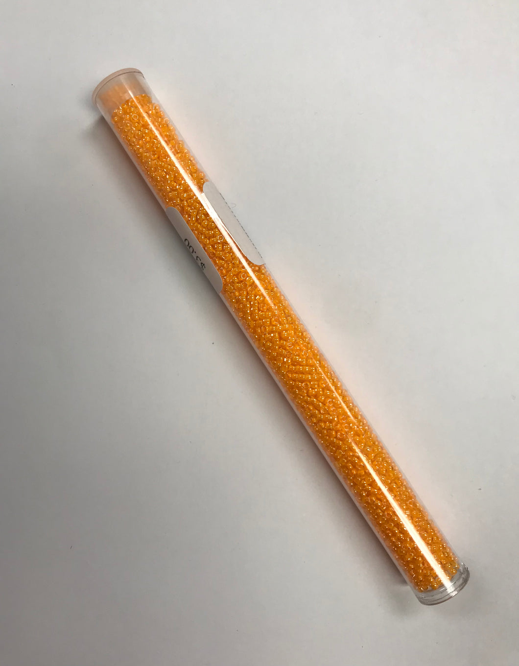 11/0 #205A Lt. Orange Fluorescent Lined Crystal